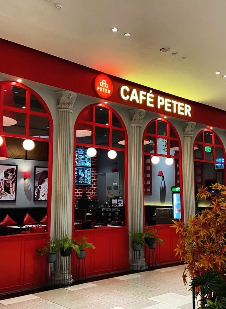 A red café interior with arched windows