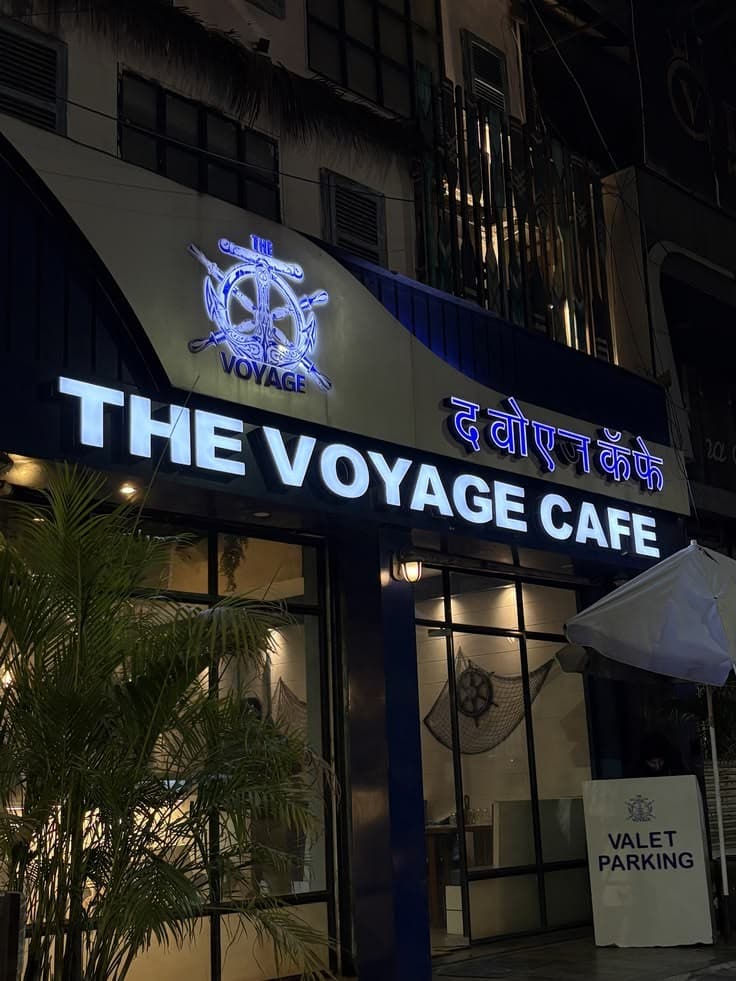 A café storefront with a blue sign at night