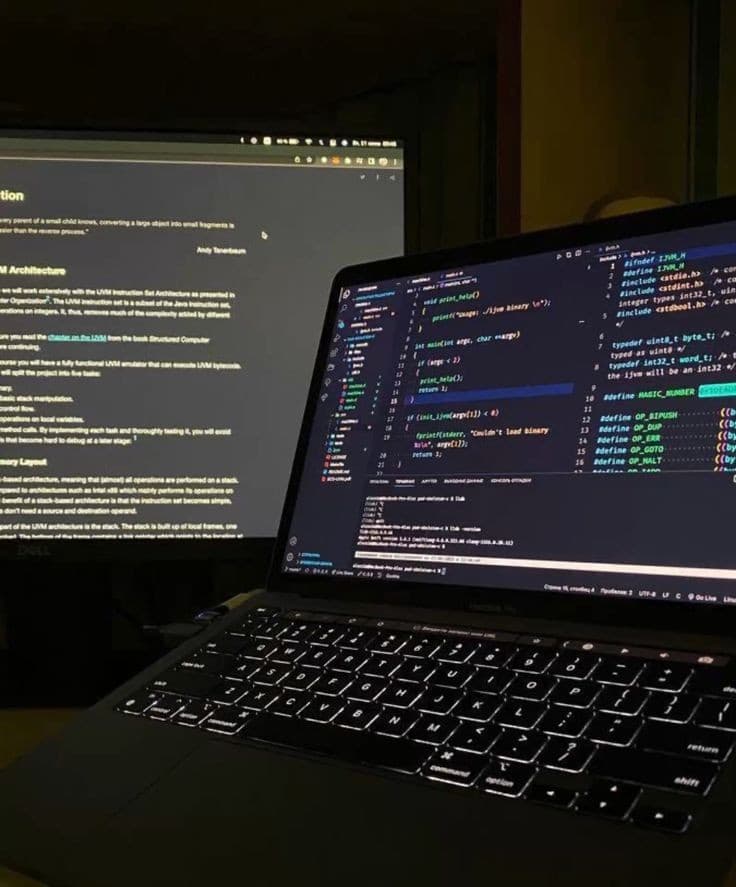 A laptop showing code in a dark room